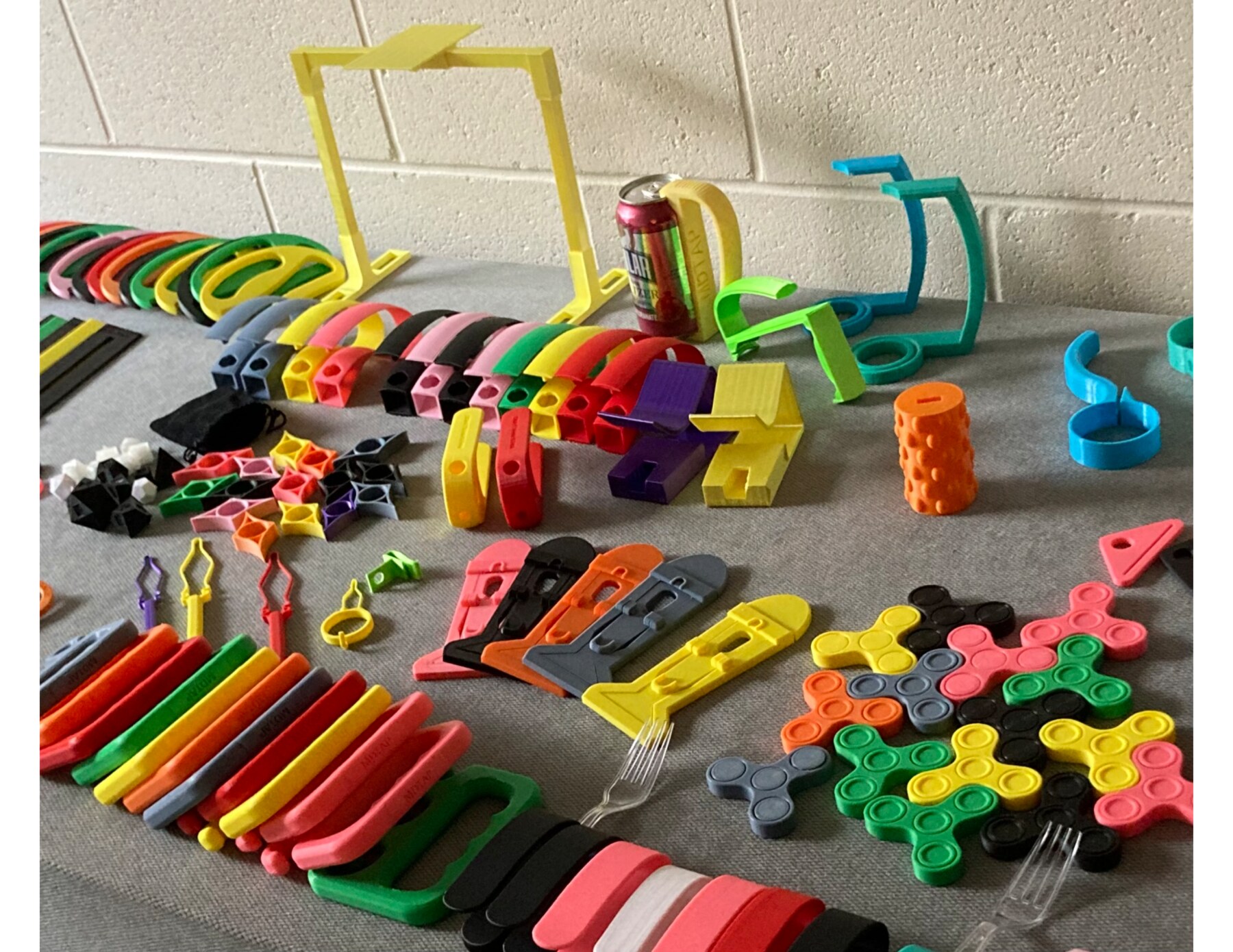 Inventory of colorful 3D-printed assistive devices prepared for distribution
