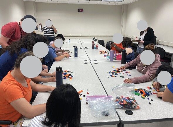 Students and mentors participating in a tactile LEGO art activity